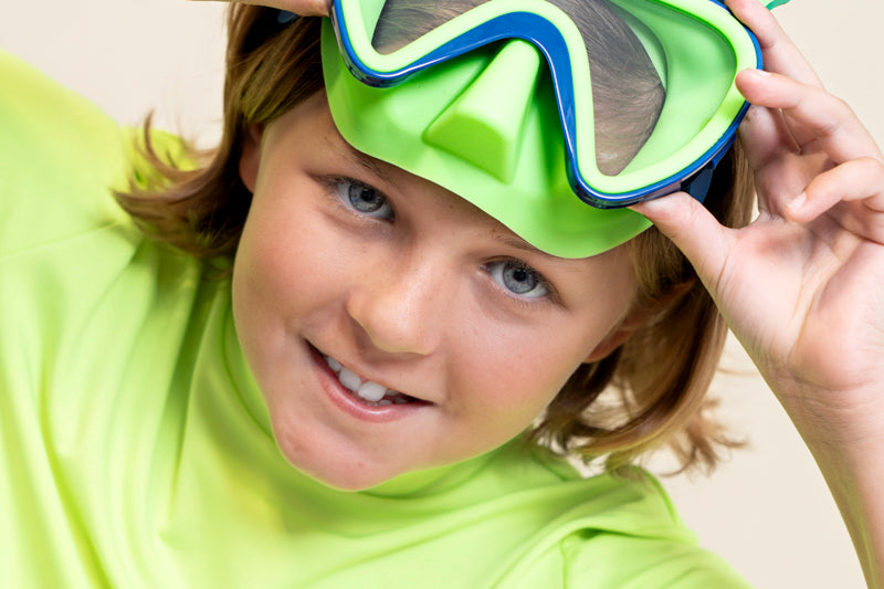 kids posing and smiling wearing creature green kids' swim mask showing green nose piece and blue colors and silicone fins 
