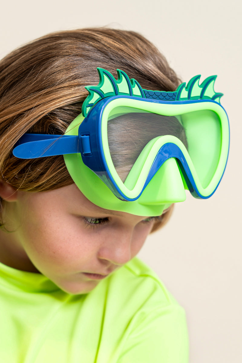 kids posing wearing creature green kids' swim mask showing green nose piece and blue colors and silicone fins with dragon scale inspired texture