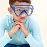 boy posing and wearing splash in color blue kids swim mask featuring a clear gasket and nose covering with a bright blue frame and strap
