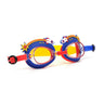 angled product shot of mini rocket ship kids swim goggles featuring a blue silicone frame with rocket ship decorations wrapping around the top of the lenses with a bright red nose piece and a red, yellow and blue swirled strap
