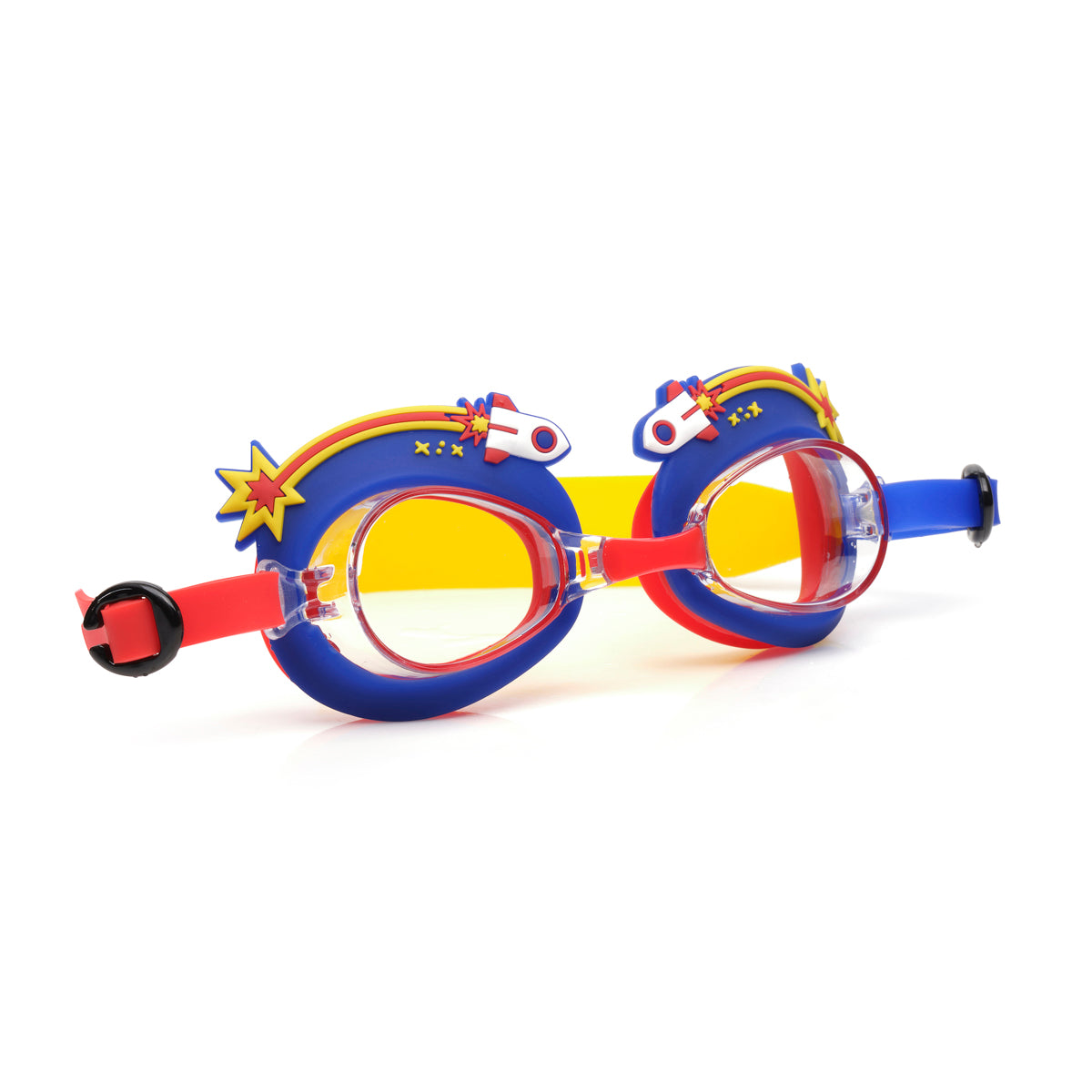 angled product shot of mini rocket ship kids swim goggles featuring a blue silicone frame with rocket ship decorations wrapping around the top of the lenses with a bright red nose piece and a red, yellow and blue swirled strap